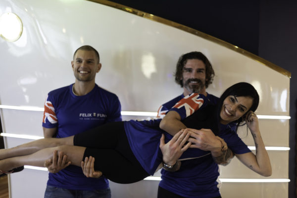 Group of two men and one woman wearing the Felix Fund blue technial running short sleeve T-shirt